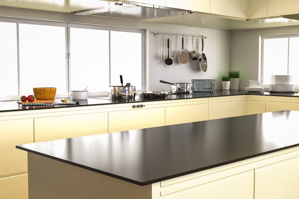 Clear black kitchen worktops with a central island and cooking area